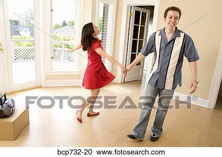 Couple dancing in new house View Large Photo Image Stock Image - Couple dancing in new house. Fotosearch