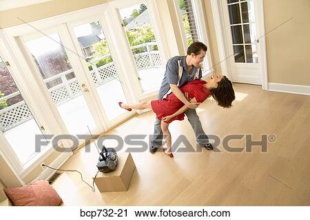 Couple dancing in new house View Large Photo Image Stock Image - Couple dancing in new house. Fotosearch