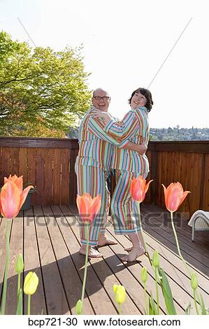 Couple dancing on patio in matching pajamas View Large Photo Image Stock Image - Couple dancing on patio in matching pajamas. Fotosearch