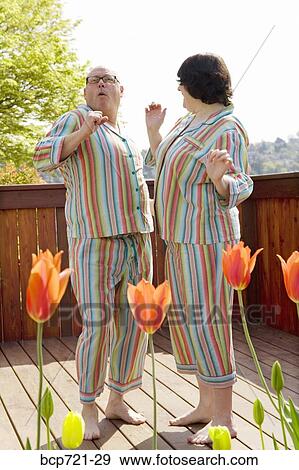 Couple dancing on patio in matching pajamas View Large Photo Image Stock Photo - Couple dancing on patio in matching pajamas. Fotosearch