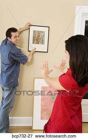 Couple hanging picture View Large Photo Image Stock Photo - Couple hanging picture. Fotosearch