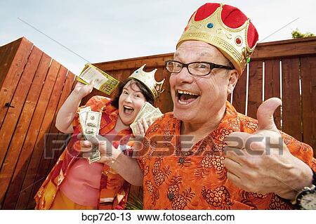 Couple in festive outfits and crowns View Large Photo Image Stock Image - Couple in festive outfits and crowns. Fotosearch