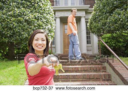 Couple in front of new house View Large Photo Image Stock Photo - Couple in front of new house. Fotosearch