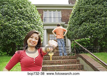 Couple in front of new house View Large Photo Image Stock Photo - Couple in front of new house. Fotosearch