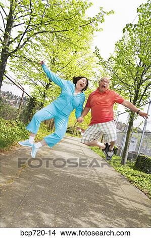 Couple jumping outside View Large Photo Image Picture - Couple jumping outside. Fotosearch