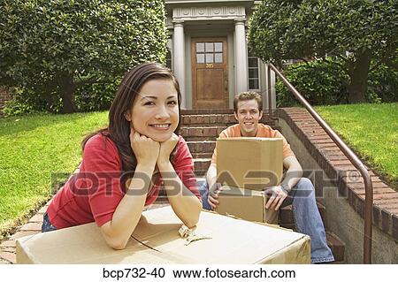 Couple moving into new house View Large Photo Image Stock Image - Couple moving into new house. Fotosearch