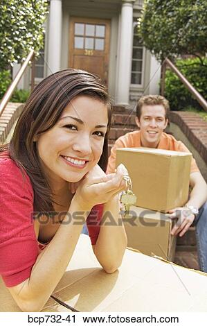 Stock Image - Couple moving into new house. Fotosearch