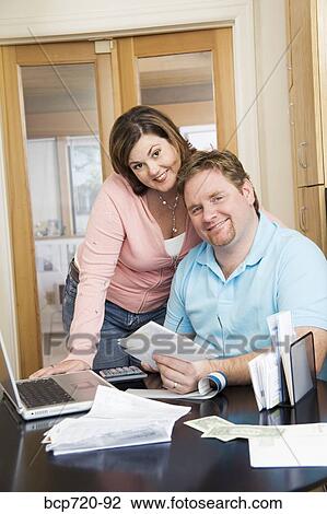 Couple paying bills View Large Photo Image Stock Image - Couple paying bills. Fotosearch