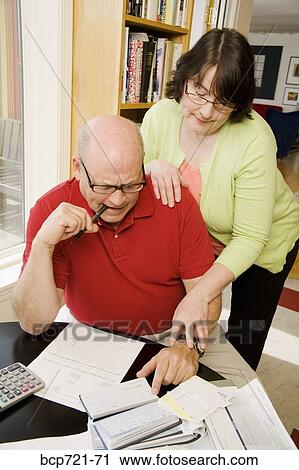Couple paying bills View Large Photo Image Stock Image - Couple paying bills. Fotosearch