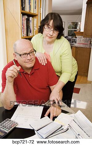 Couple paying bills View Large Photo Image Stock Image - Couple paying bills. Fotosearch