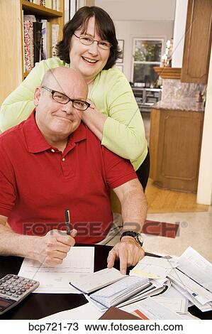 Couple paying bills View Large Photo Image Stock Image - Couple paying bills. Fotosearch