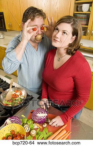 Couple playing with food while cooking View Large Photo Image Picture - Couple playing with food while cooking. Fotosearch