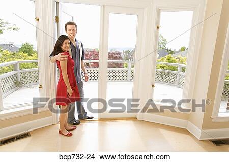 Couple standing in doorway of new house View Large Photo Image Picture - Couple standing in doorway of new house. Fotosearch
