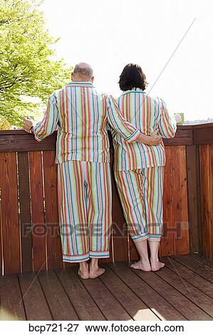 Couple standing on patio in matching pajamas View Large Photo Image Stock Photo - Couple standing on patio in matching pajamas. Fotosearch
