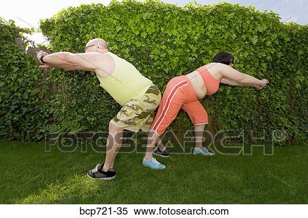 Couple stretching in backyard View Large Photo Image Stock Photography - Couple stretching in backyard. Fotosearch