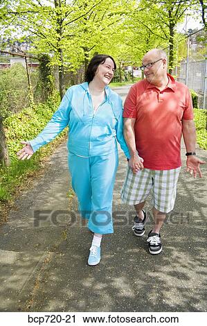 Couple walking outside View Large Photo Image Stock Image - Couple walking outside. Fotosearch