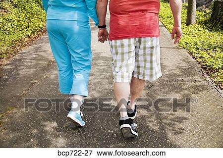 Couple walking together outside View Large Photo Image Stock Photo - Couple walking together outside. Fotosearch