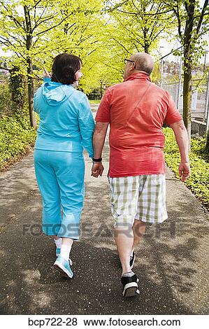 Couple walking together outside View Large Photo Image Stock Photo - Couple walking together outside. Fotosearch