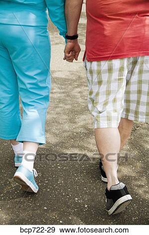 Couple walking together outside View Large Photo Image Stock Photo - Couple walking together outside. Fotosearch