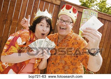 Couple wearing festive outfits and crowns View Large Photo Image Stock Image - Couple wearing festive outfits and crowns. Fotosearch