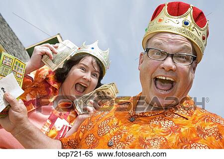 Couple wearing festive outfits and crowns View Large Photo Image Stock Photography - Couple wearing festive outfits and crowns. Fotosearch