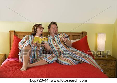 Couple wearing matching pajamas in bed View Large Photo Image Picture - Couple wearing matching pajamas in bed. Fotosearch