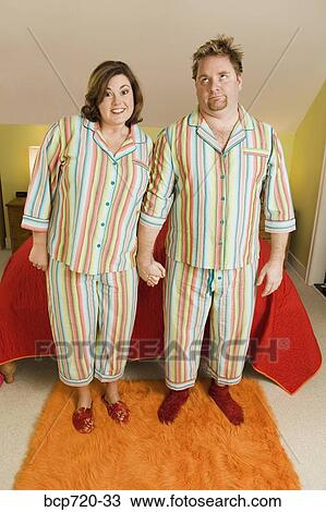 Stock Image - Couple wearing matching pajamas. Fotosearch