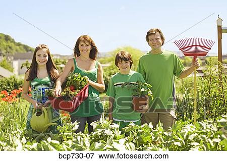 Family in in vegetable garden View Large Photo Image Stock Photo - Family in in vegetable garden. Fotosearch