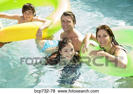 Family in swimming pool View Large Photo Image Stock Photo - Family in swimming pool. Fotosearch
