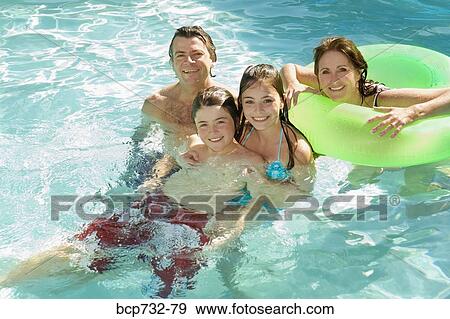 Family in swimming pool View Large Photo Image Stock Photo - Family in swimming pool. Fotosearch