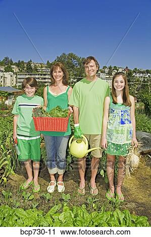 Family in vegetable garden View Large Photo Image Stock Image - Family in vegetable garden. Fotosearch