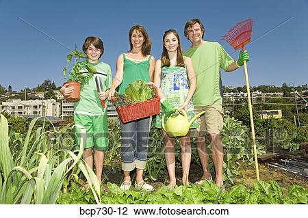 Family in vegetable garden View Large Photo Image Stock Image - Family in vegetable garden. Fotosearch