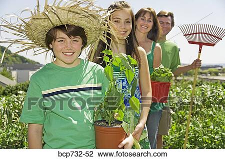 Family in vegetable garden View Large Photo Image Stock Image - Family in vegetable garden. Fotosearch