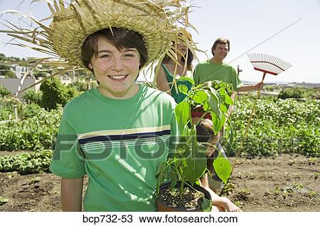 Family in vegetable garden View Large Photo Image Stock Image - Family in vegetable garden. Fotosearch