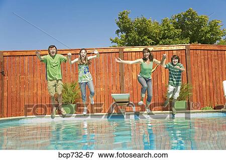 Stock Photo - Family jumping into swimming pool. Fotosearch