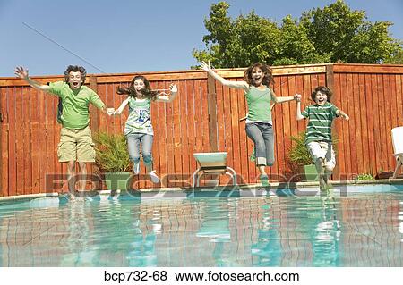Family jumping into swimming pool View Large Photo Image Stock Photo - Family jumping into swimming pool. Fotosearch