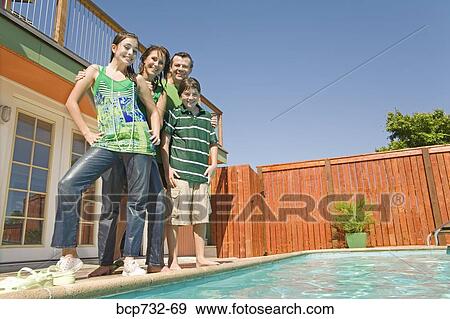 Family next to swimming pool View Large Photo Image Stock Photo - Family next to swimming pool. Fotosearch