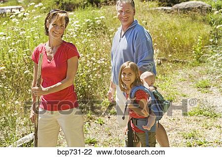 Stock Image - Family with baby hiking. Fotosearch
