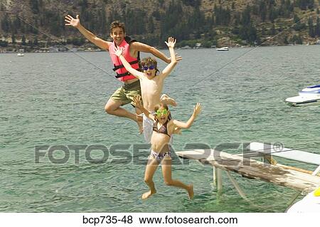 Stock Photo - Father and children jumping into water. Fotosearch