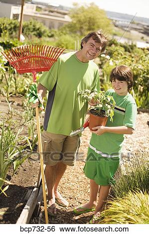 Father and son in vegetable garden View Large Photo Image Stock Photograph - Father and son in vegetable garden. Fotosearch