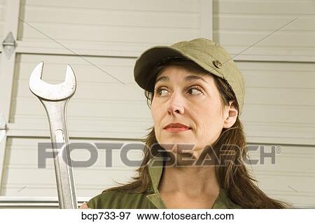 Female auto mechanic holding wrench View Large Photo Image Stock Photo - Female auto mechanic holding wrench. Fotosearch