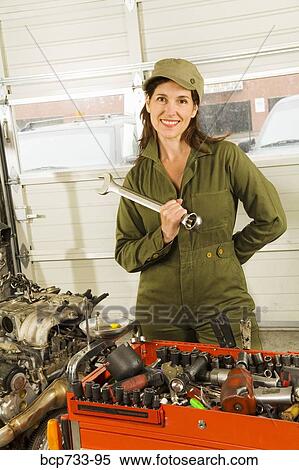 Female auto mechanic next to engine View Large Photo Image Stock Photography - Female auto mechanic next to engine. Fotosearch