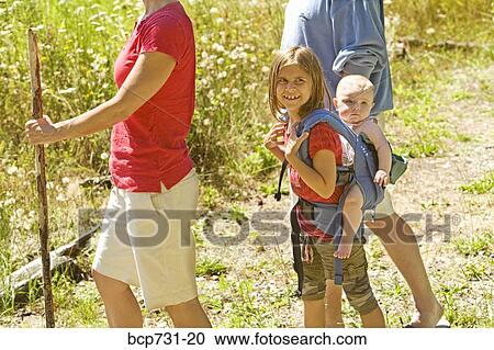 Girl carrying baby sibling on back View Large Photo Image Stock Image - Girl carrying baby sibling on back. Fotosearch