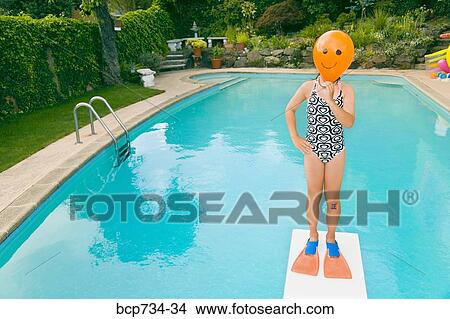 Girl with balloon in front of face over swimming pool View Large Photo Image Picture - Girl with balloon in front of face over swimming pool. Fotosearch