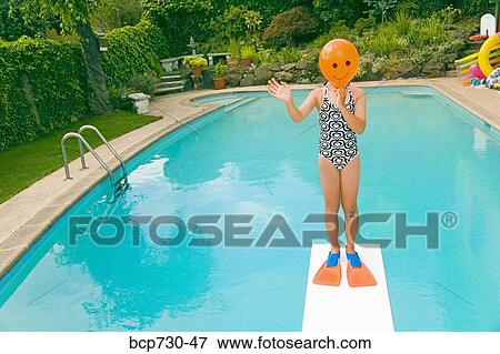 Girl with balloon in front of face over swimming pool View Large Photo Image Stock Photo - Girl with balloon in front of face over swimming pool. Fotosearch