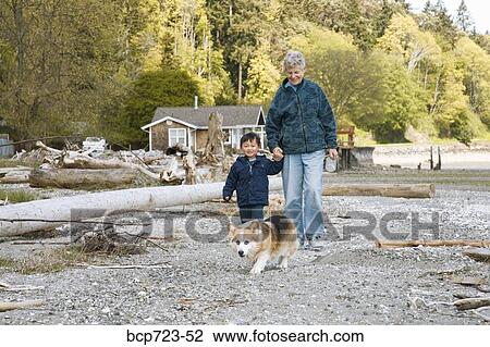 Grandmother and grandson walking on beach View Large Photo Image Stock Image - Grandmother and grandson walking on beach. Fotosearch