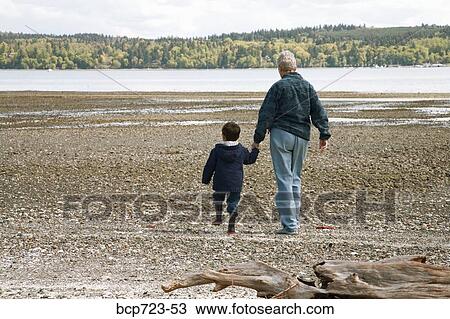 Grandmother and grandson walking on beach View Large Photo Image Stock Image - Grandmother and grandson walking on beach. Fotosearch