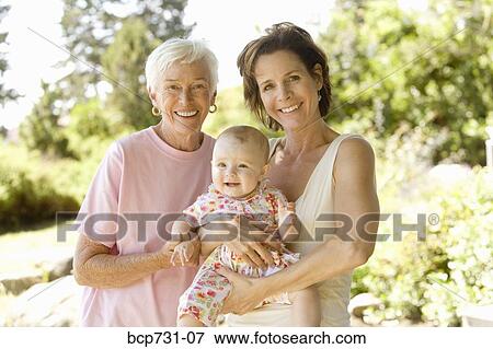 Grandmother and mother holding baby View Large Photo Image Stock Photo - Grandmother and mother holding baby. Fotosearch