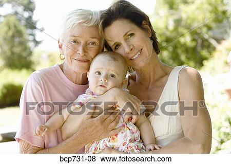 Grandmother and mother holding baby View Large Photo Image Stock Photo - Grandmother and mother holding baby. Fotosearch