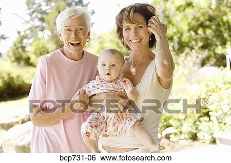 Grandmother and mother holding baby View Large Photo Image Stock Photograph - Grandmother and mother holding baby. Fotosearch